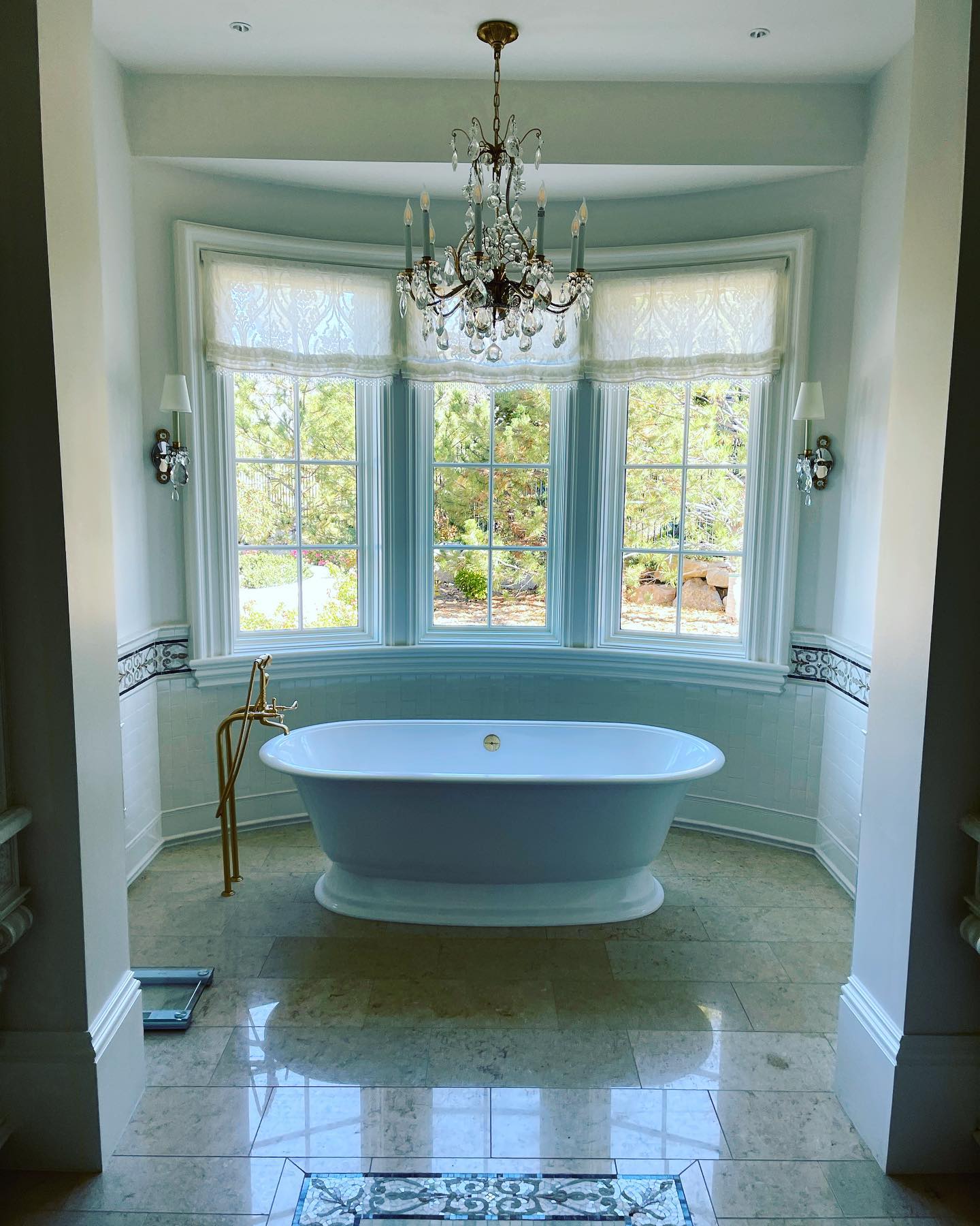 Bright luxury bathroom framed by three professionally cleaned bay windows