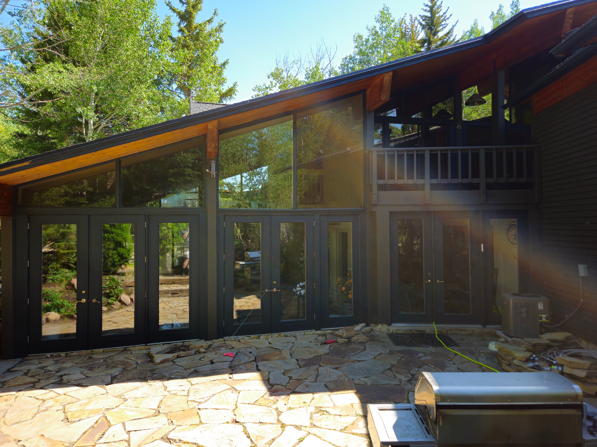 Professionally cleaned expansive windows and glass doors on a wooded Northern Utah home