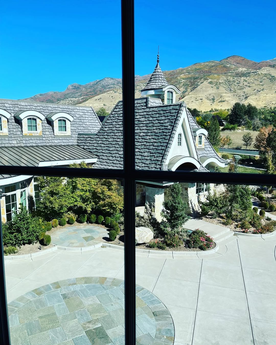 Crystal-clear window framing a luxury Northern Utah home and mountain view