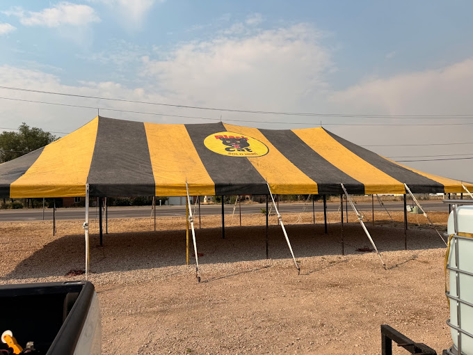 Large black and yellow event canopy after specialty exterior cleaning